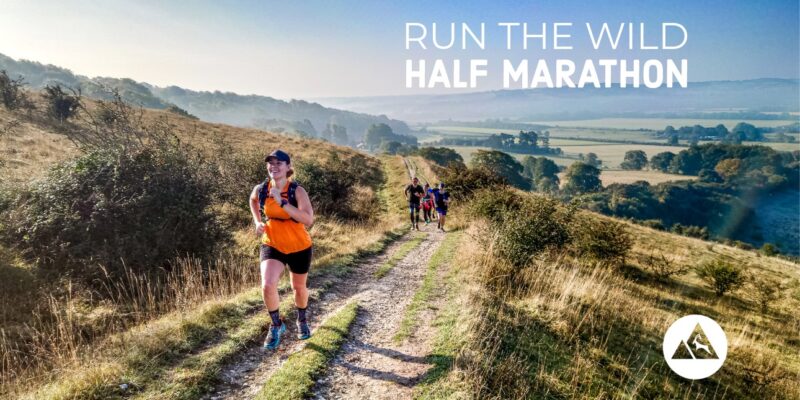 Trail runner running onto the Chiltern Hills on the Run the Wild Half Marathon