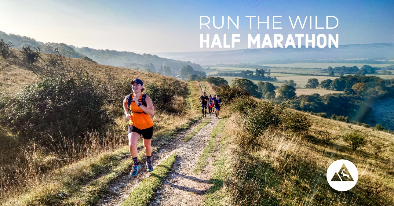 Trail runner running onto the Chiltern Hills on the Run the Wild Half Marathon