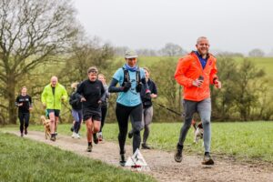 Trail runners running in the Chilterns on the Berko 10km organised by Run the Wild