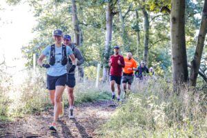 Trail runners completing the Water & Windmill 10 miler in the Chilterns with Run the Wild