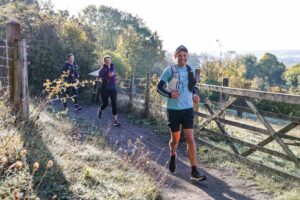 Trail runners completing the Water & Windmill 10 miler in the Chilterns with Run the Wild