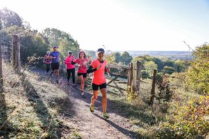 Trail runners completing the Water & Windmill 10 miler in the Chilterns with Run the Wild