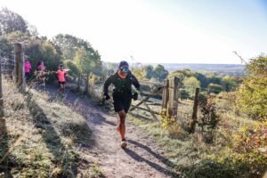 Trail runners completing the Water & Windmill 10 miler in the Chilterns with Run the Wild
